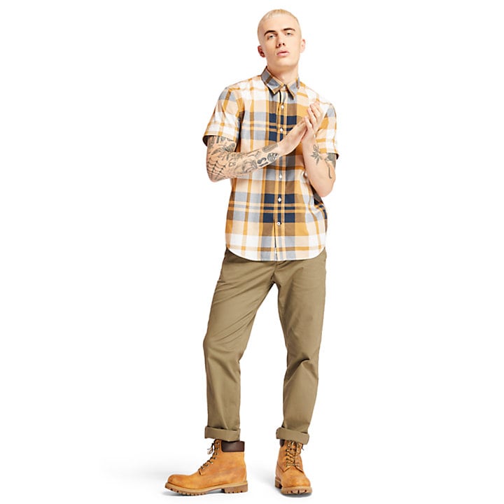 model-wearing-yellow-white-navy-check-shirt-with-classic-timberland-boots