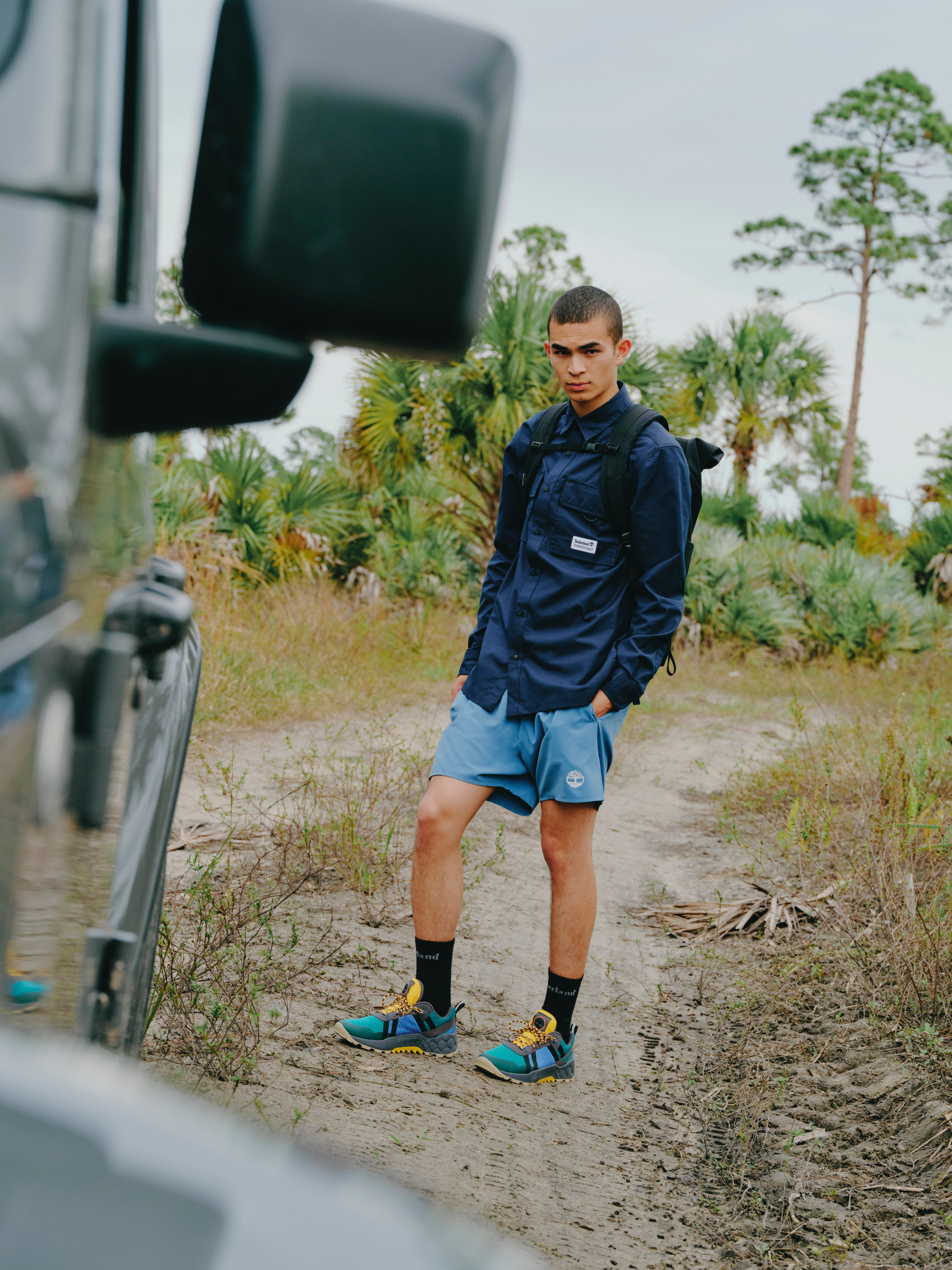 Man by car wearing Timberland clothing