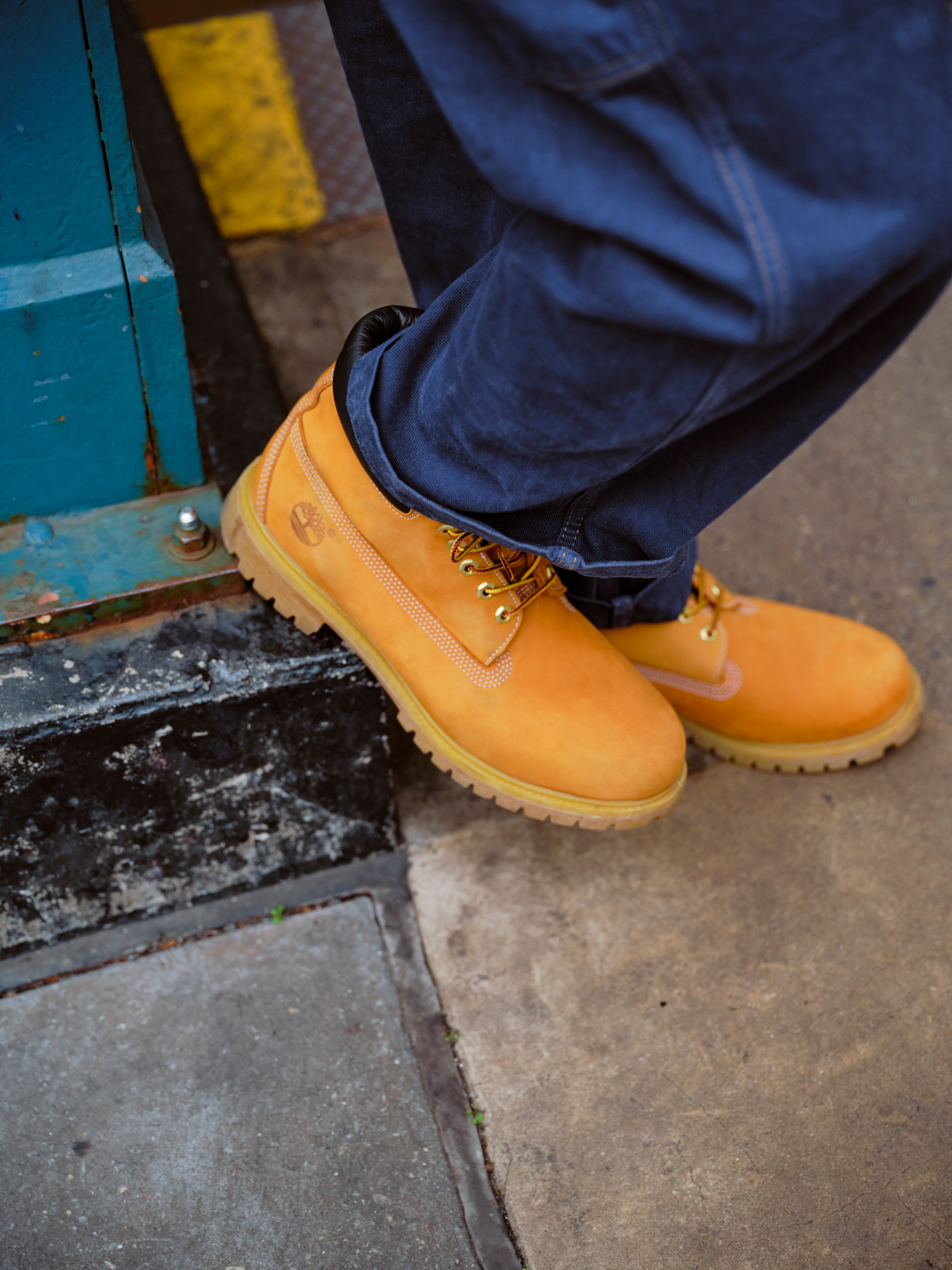 Model standing on orange block in Timberland boots