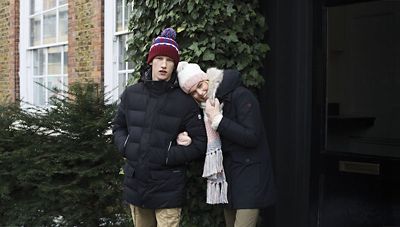 Man and woman dressed in hats and jackets