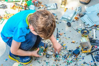 A child looking at plastic electronic components
