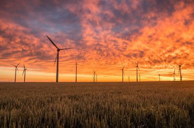 Wind turbines against sunset