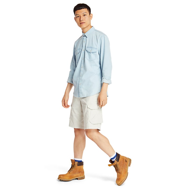 man-wearing-denim-shirt-with-cargo-shorts-and-original-timberland-boots