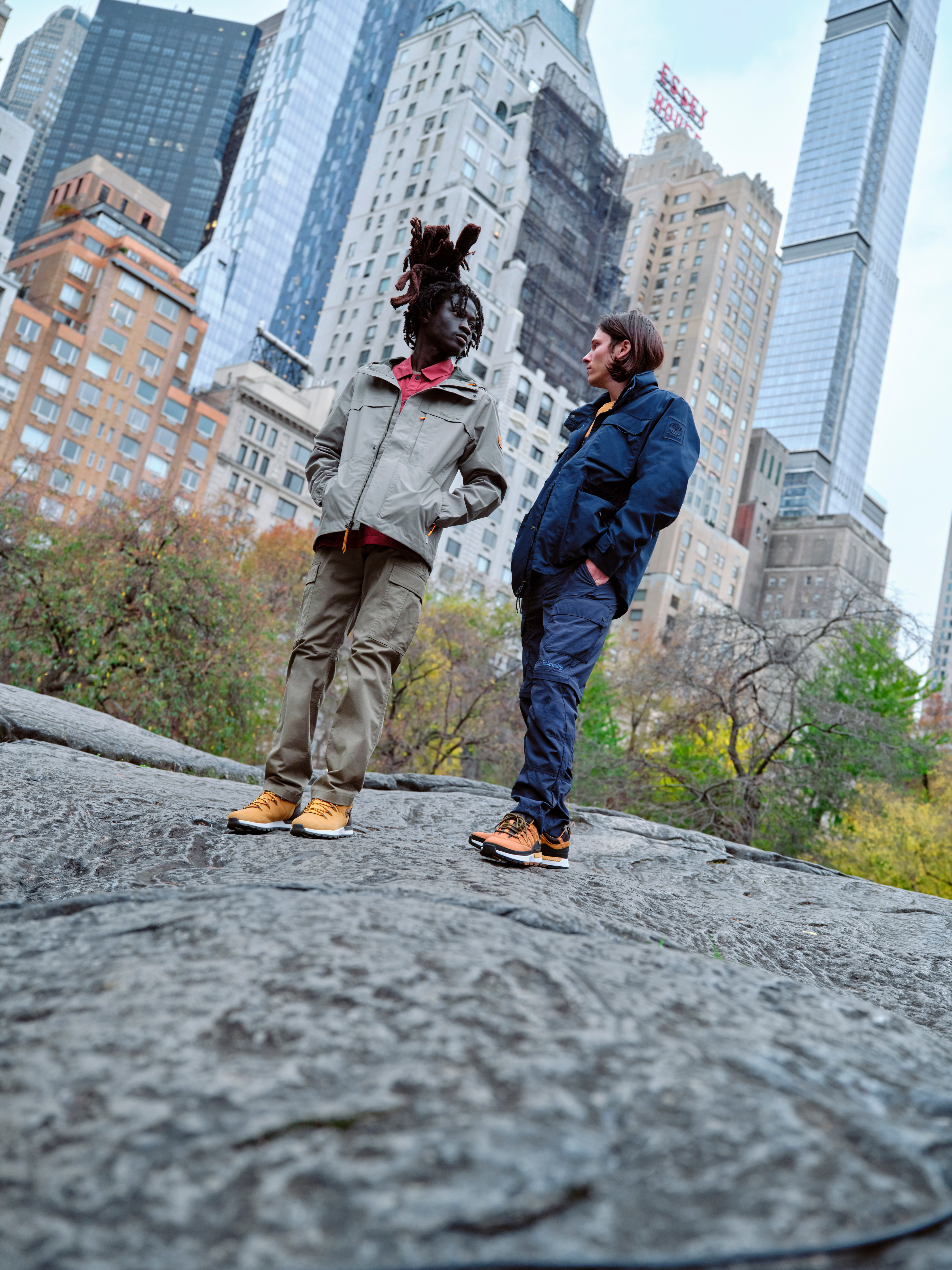 Men in Timberland clothing standing on rock in park