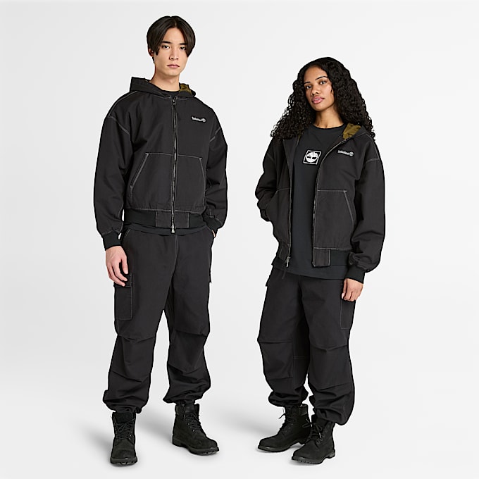 All Gender Bomberjacke aus gewaschenem Duck-Canvas mit Kapuze in Schwarz - 1